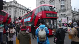 Cars sound horns in irritation as Youth Climate Strike protestors line in in the middle of the road for 7 minutes in Piccadilly Circus