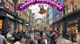 Busy Carnaby Street with Christmas decorations, London, UK 12 December 2021