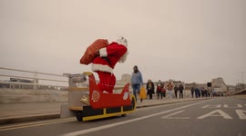 'Santa Cruise' drops presents off while riding electric sleigh through streets of London