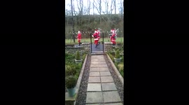 UK resident opens door to find band of Santas marching down street