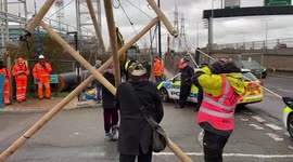Extinction Rebellion activists block gates at London Energy with a bamboo structure in protest against Edmonton incinerator