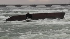 Historic Niagara falls Iron scow hangs in there during another massive wind and waves storm this past weekend on the great lakes that threated to send the barge over the falls
