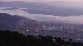 Watch this stunning footage as blankets of cloud fall from the mountain to cover Barcelona in waves of fog