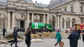 French farmers dump huge pile of STRAW outside Paris government building in anger at pesticides ban