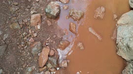 Enduro motorcycles in a wet and permitted area, crossing a river. Aerial with drone