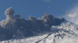 Huge clouds of ash spew from snow-capped crater of Mount Etna