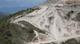 Enduro motorcycles in a wet and permitted area, crossing a river. Aerial with drone