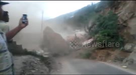 Locals watch on as landslide crashes into power line causing explosion in India