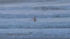 Brave swimmer braces the cold at Newquay beach in Cornwall