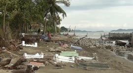 Graves scattered across Indonesian beach after high tide damages cemetery