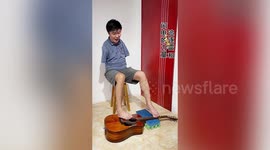 This armless Chinese man has mastered playing the guitar with his feet