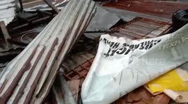 Typhoon Rai tears down roofs in the Philippines killing at least one person