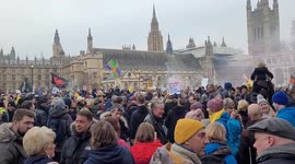 UK anti lockdown protests wave flags and banners on Parliament Square