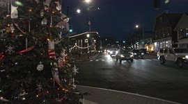Christmas tree near  Main street in downtown  with evening lights from traffic on busy Post road