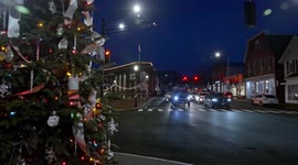 Christmas tree near  Main street in downtown  with evening lights with focusing on traffic on busy Post road