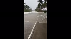 Storm surge rushes over road as Typhoon Rai (Odette) hits the Philippines