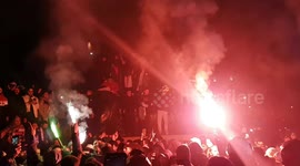 Hundreds of jubilant Algeria football supporters celebrate into the night at London's Trafalgar Square after FIFA Arab Cup win