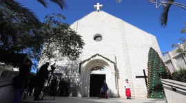 Palestinian Christians attend a mass ahead of Christmas celebrations, at the Roman Catholic Church of the Holy Family.