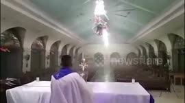 Priest continues to hold mass as super typhoon Rai batters church in the Philippines