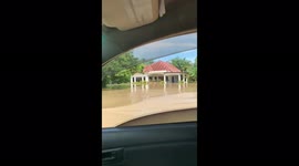 Vehicle drives through deep floods as Malaysia is inundated with heavy rains