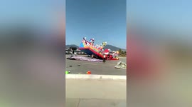 Children thrown off bouncy castle in China as gusts of wind twirl inflatable into air