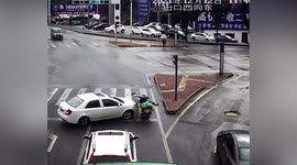 Car drifts on slippery road before crashing into motorcyclist in China