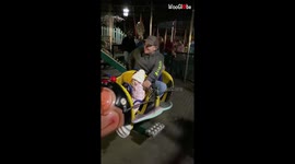 Daddy's stuck! Man battles to get out of tiny kids' ride as baby slides off her seat