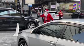 Car park attendants wear Santa costumes at shopping mall in Thailand