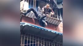 Chinese man climbs water pipe to save elderly man hanging upside down on balcony