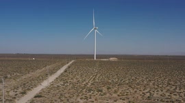 Wind power generator in the valley of Puerto Peñasco, Mexico. Sonoran Desert blades of a wind turbine in electric energy, electric generator moved by a turbine driven by the wind, blades, warm color at sunset, power poles and cables, CFE