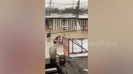 Youngsters play on rafts during super typhoon Rai flood in the Philippines
