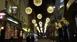 Villiers Street Christmas lights shine with golden globes - London