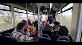 A man starts playing backpipe on a bus on way back from winter solstice in Stonehenge