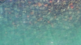 Aerial view approaching ocean waves, turquoise blue water and rocks at Puerto Peñasco bay in Sonora, Mexico. landscape of beach, sea, hotel and real estate industry. Gulf of California desert. Sea of Cortez, Bermejo Sea