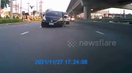 Car gets stuck in open manhole on busy Thailand road