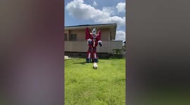 Anime enthusiast walks dog while wearing cardboard mecha suit in Japan