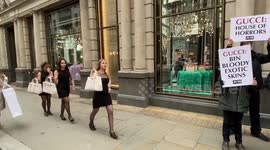 PETA activists stage a catwalk outside Gucci with bloody handbags in protest against exotic skins, London UK 23 December 2021
