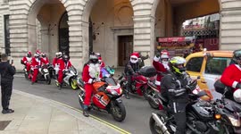 Convoy of motorcycling Santas pass through Piccadilly Circus, London