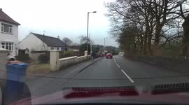 Dangerous driving. Car overtaking just before a roundabout and almost colliding with a vehicle turning left.