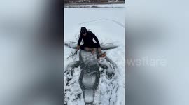 Self-taught Chinese artist intricately carves crocodile and dolphin into frozen river