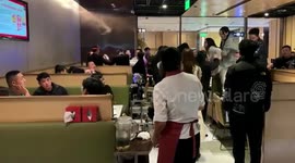 Diners in China continue to celebrate birthday despite intense fight on next table