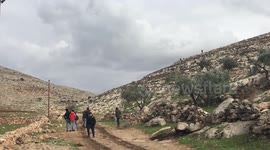Palestinian protesters clash with Israeli troops, following a protest against settlement in Beit Dajan