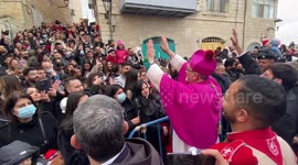 Latin Patriarch of Jerusalem greets crowds as he attends Christmas celebrations