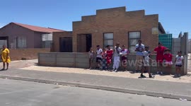 Community activist provide a Christmas meal and musical performance to poor children in Cape Town