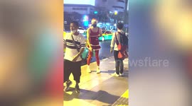 Reveller wears Santa Claus red dress and leggings in Bangkok