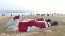 Giant Santa made of sand chills at Indian beach