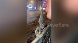 Curious student tries licking iron fence in cold winter to see if it gets stuck