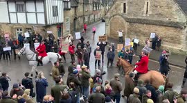 Avon vale hunt, Lacock. Hunt arriving with vocal opposition
