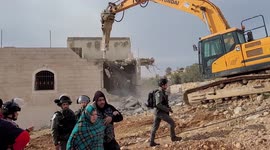 Israeli soldiers stand guard as authorities demolish Palestinian house