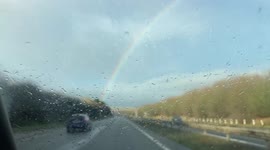 Rainbow filmed from car passenger seat